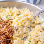 Käsespätzle on a spoon and in a frying pan.