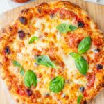 Overhead photo of pizza on a wooden board.